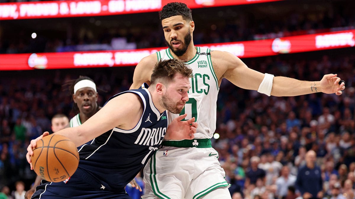 Mavericks Luka Doncic drives on Celtics Jayson Tatum during 2024 NBA Finals